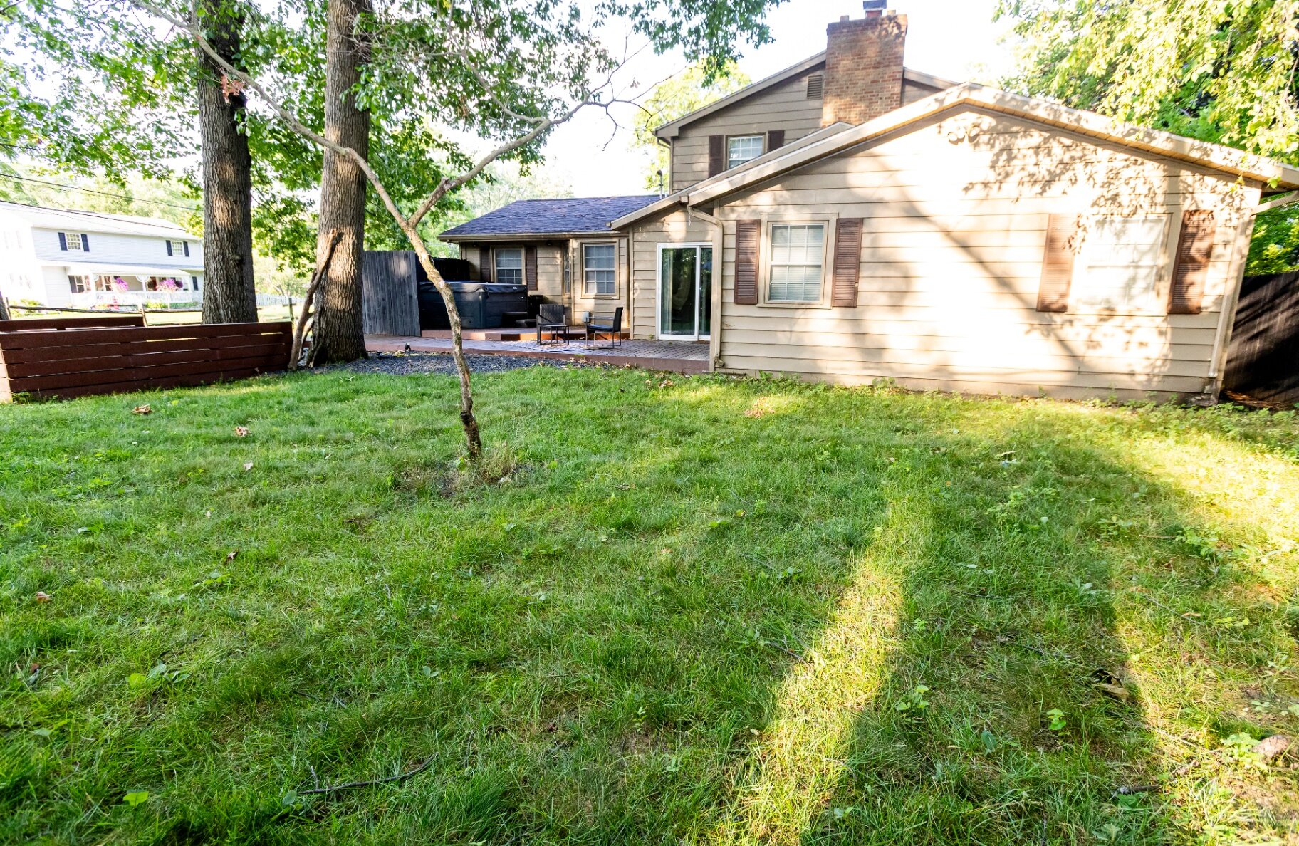 Backyard with private hot tub and deck seating