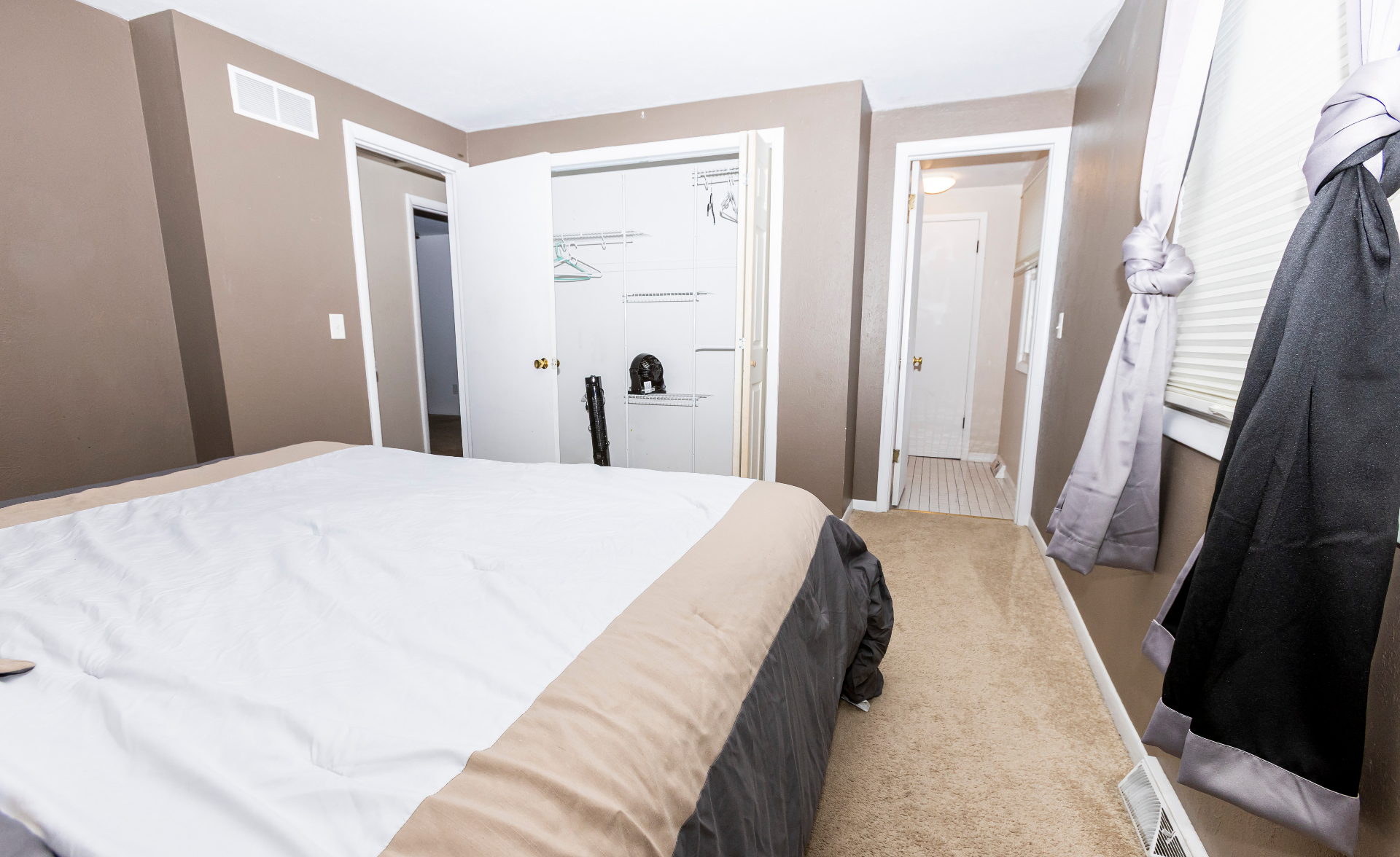 Primary bedroom showing the closet and doorway toward the bath