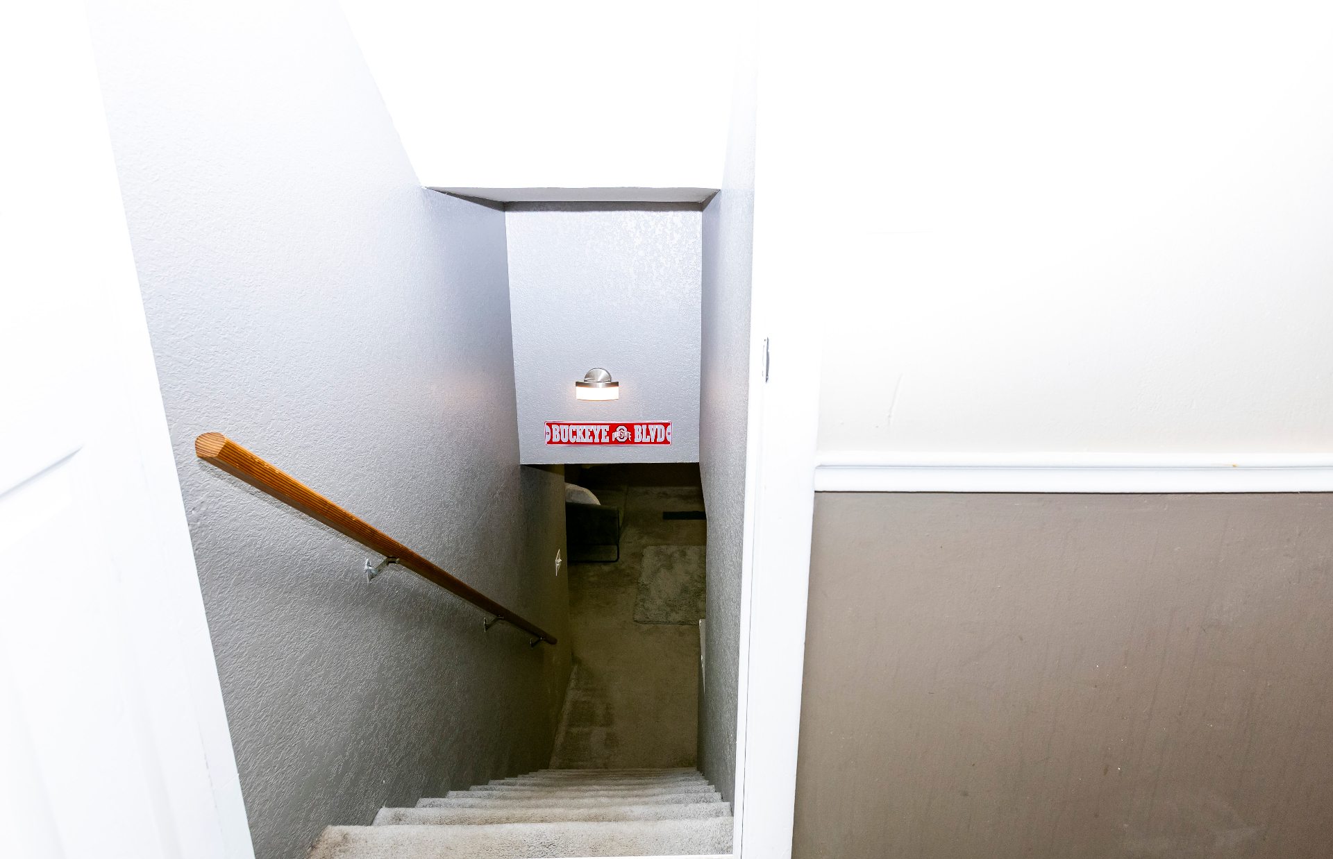 Staircase descending to the lower-level lounge and media room