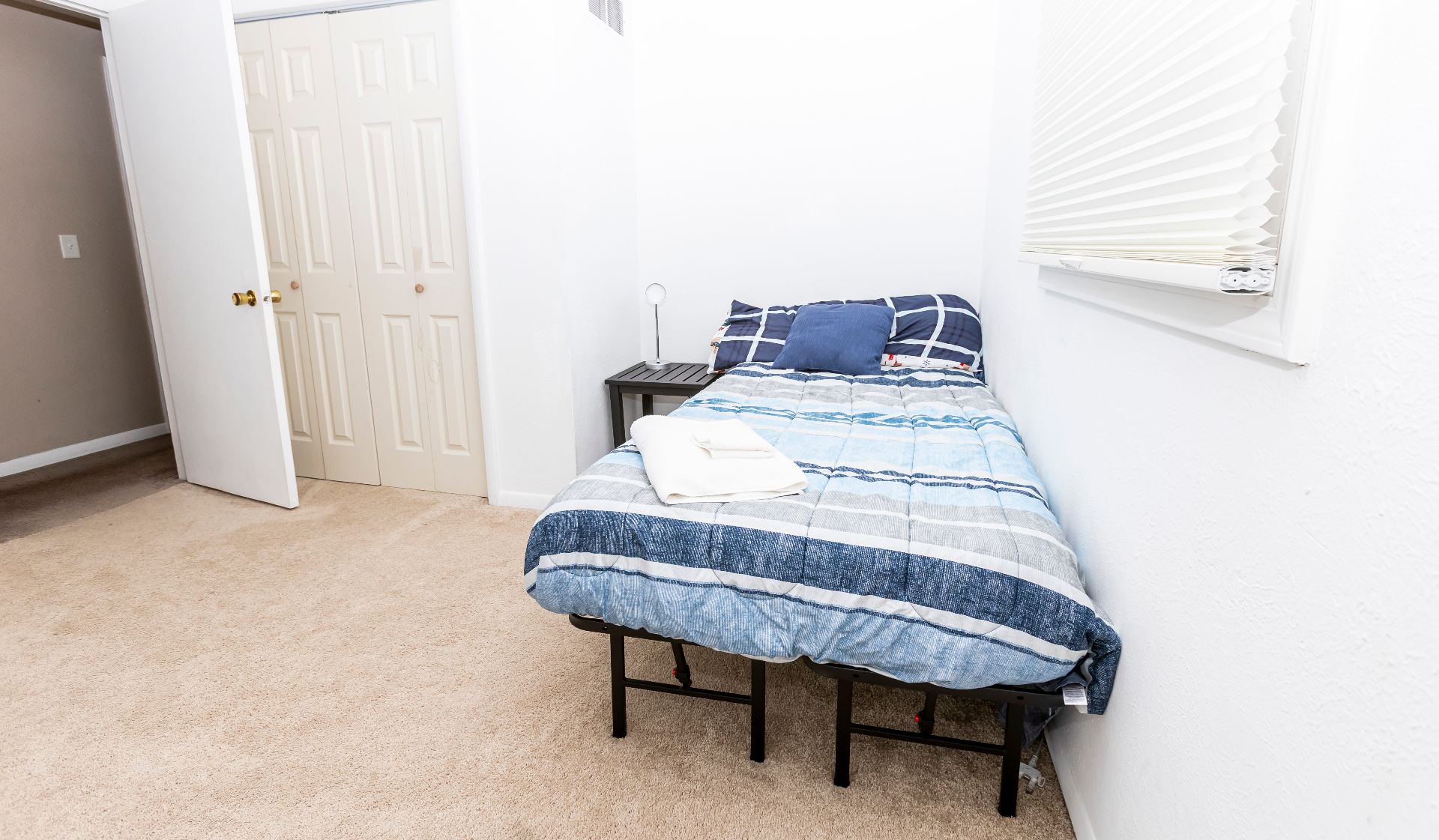 Additional bedroom with a twin bed, side table, and bright window