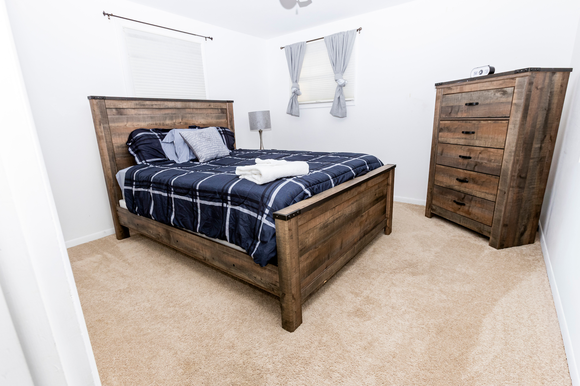 Third bedroom with a rustic wood queen bed and matching dresser