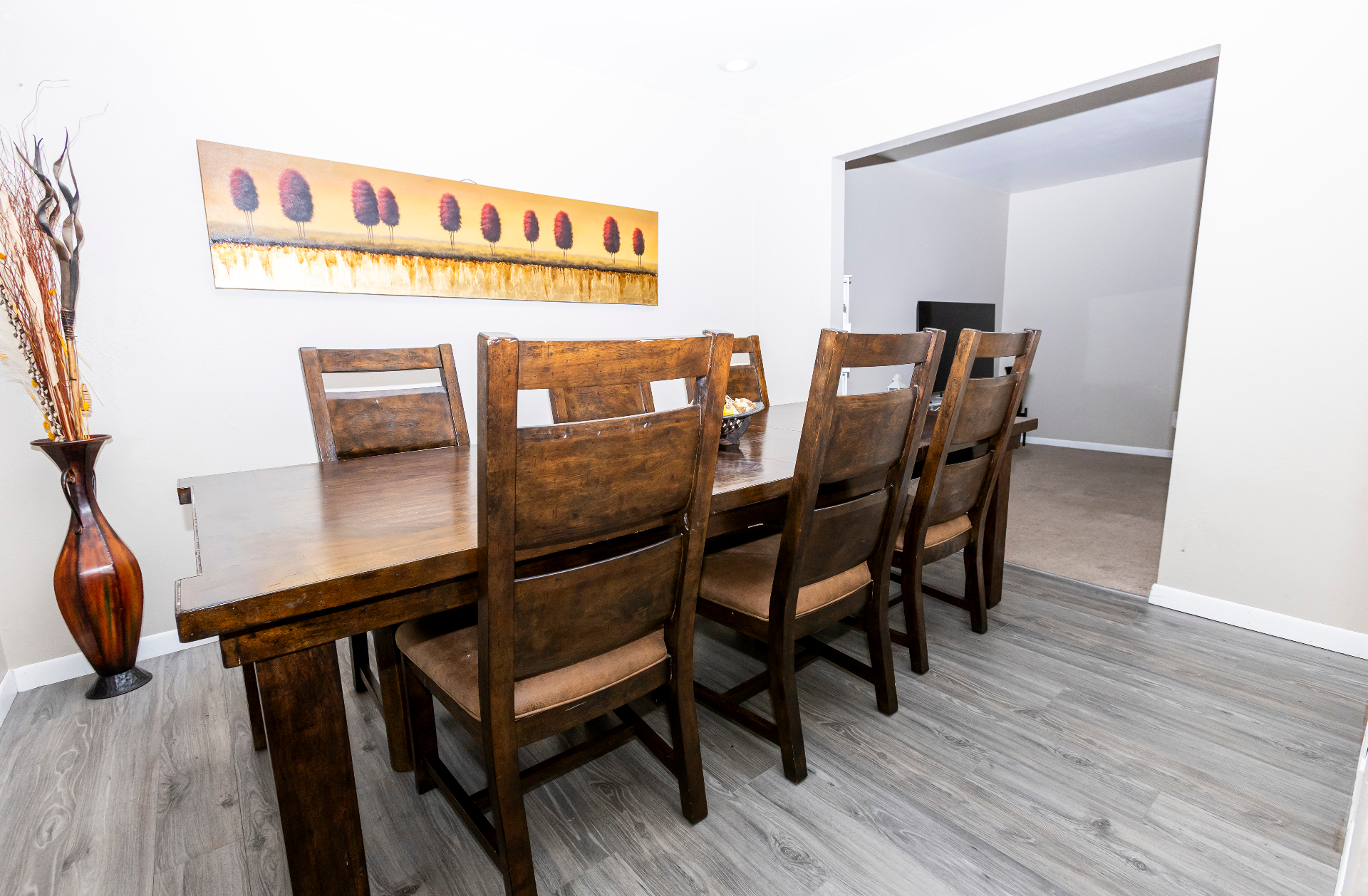 Dining area opening toward the lounge with seating for a full group